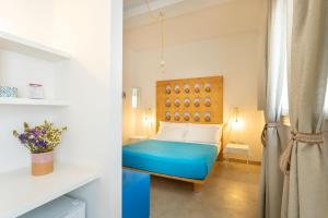 a bedroom with a blue bed in a room at TerreAmare Agriturismo in Porto Cesareo