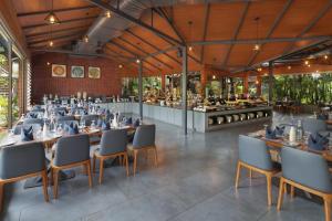 a restaurant with long tables and chairs and a buffet at Treat Beach Resort in Bordi