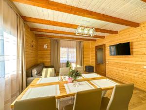 a dining room with a table and chairs at KaVacottage in Krivorovnya
