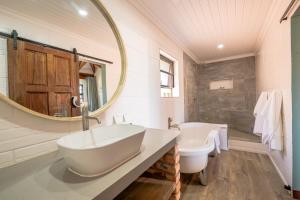 a bathroom with a large mirror and a sink at Hannah Game Lodge in Ohrigstad +31 photos