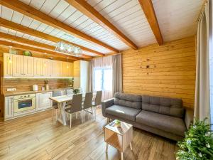 a living room with a couch and a table at KaVacottage in Krivorovnya