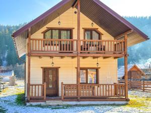 a large wooden house with a large deck at KaVacottage in Krivorovnya
