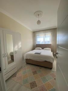 a bedroom with a bed and a large mirror at Ada Mevan Otel in Ipekyolu