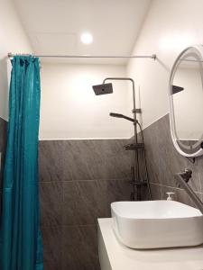 a bathroom with a sink and a mirror at Viajeros Apartelle in Valencia