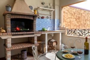 a kitchen with a stone oven and a table with a table sidx sidx at Can Nentia in Fonteta