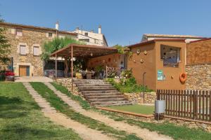 a house with stairs leading up to a building at Can Nentia in Fonteta