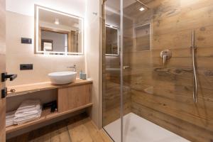 a bathroom with a sink and a shower at Vacanze la Malga in Predazzo +51 photos