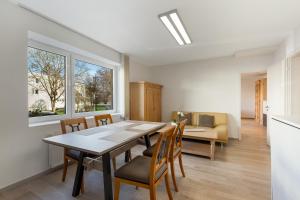 a dining room with a table and chairs and a couch at Ferienwohnung Bernhard in Wermelskirchen