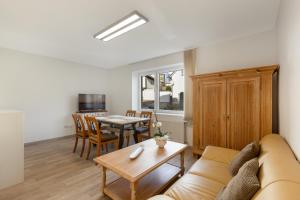 a living room with a couch and a table at Ferienwohnung Bernhard in Wermelskirchen
