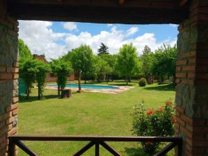 a view of a yard with a swimming pool at Cabañas La Rosada in Santa Rosa de Calamuchita