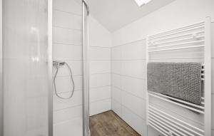 a shower in a bathroom with white tiled walls at Gut Barzig in Großräschen +28 photos
