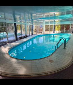 a large swimming pool in a large building at Le Cocon des 2 Alpes, Spa, Jacuzzi, Piscine Chauffee in Les Deux Alpes
