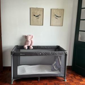 a pink teddy bear sitting on top of a crib at Casa Žerotín in Funchal