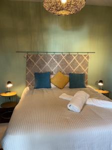 a bedroom with a large bed with two pillows at Casa Žerotín in Funchal