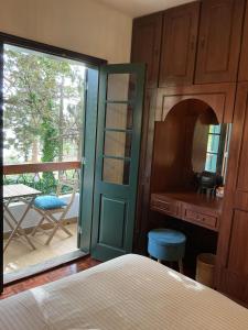 a bedroom with a door leading to a balcony at Casa Žerotín in Funchal +45 photos