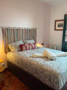 a bedroom with a bed with a headboard and pillows at Casa Žerotín in Funchal