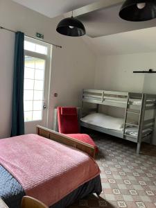 a bedroom with two bunk beds and a window at La Berge in La Flocellière