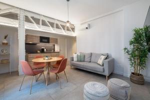 a living room with a table and chairs and a couch at Diana Suites 23 in Málaga