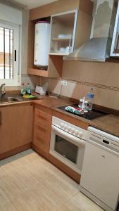 a kitchen with a sink and a stove top oven at Marina Dor holidays in Oropesa del Mar