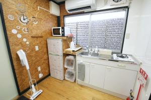 a kitchen with a sink and a window at halfGlamping星音 B in Nakijin +44 photos