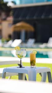 a glass of wine and a slice of bread on a table at Lena Village - Hotel and Spa in Mortágua