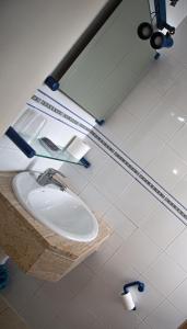 a bathroom with a sink and a mirror at Pensión Juan Pedro in Roquetas de Mar