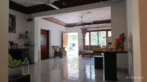 a kitchen and living room with a table with fruit on it at White Umbrella - Homestay in Beruwala