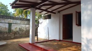 a porch of a house with a wooden roof at White Umbrella - Homestay in Beruwala