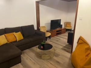 a living room with a couch and a table at Alvarenga House in Maia +10 photos