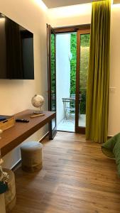 a living room with a tv and a wooden floor at B&B Villa Grace in Bari