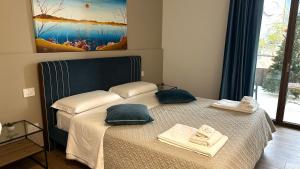 a bedroom with a bed with towels on it at B&B Villa Grace in Bari +32 photos