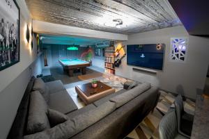 a living room with a couch and a pool table at Pyrgiou suites in Thessaloniki