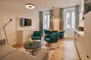 a living room with a couch and chairs and a table at URBANAUTS STUDIOS Ginnastica in Trieste