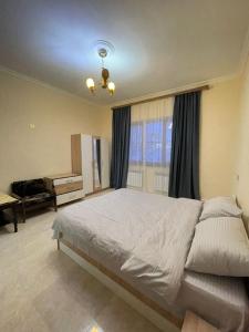 a bedroom with a large bed and a piano at AparanQ