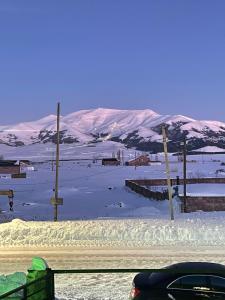 a car parked on the side of a snow covered road at AparanQ  +12 photos