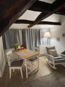 a dining room with a table and two chairs at Fachwerk Juwel in Melsungen +22 photos
