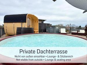 a large swimming pool in front of a yurt at Panorama Penthouse mit Dachterrasse - Sauna & Whirlpool in Karlsruhe