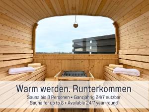 a sauna with a window in a wooden building at Panorama Penthouse mit Dachterrasse - Sauna & Whirlpool in Karlsruhe