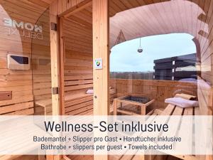 a wooden sauna with a bench and a table at Panorama Penthouse mit Dachterrasse - Sauna & Whirlpool in Karlsruhe +42 photos