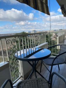 a table and chairs on a balcony with a view at Appartamento 47 in Novara