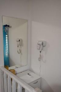 a white bathroom with a mirror and a sink at Ostria spiti 5 in Aigio +17 photos