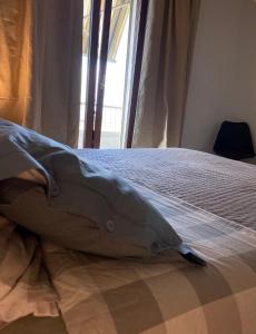 a bed with a pillow on it in a bedroom at Appartamento 47 in Novara