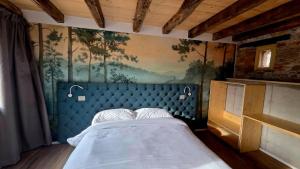 a bedroom with a bed with a painting on the wall at Dolce Bacio in Valdobbiadene +47 photos