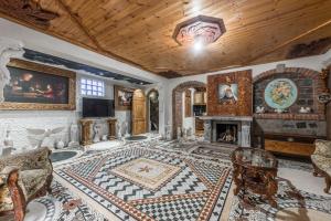 a living room filled with furniture and a fireplace at Kanuni Authentic Albanian House by PikHost in Shkodër