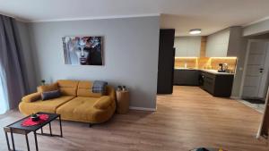 a living room with a couch and a table at By The Pool Apartments #8 in Velingrad