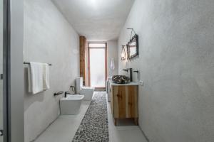 a white bathroom with two toilets and a sink at Kanuni Authentic Albanian House by PikHost in Shkodër +47 photos