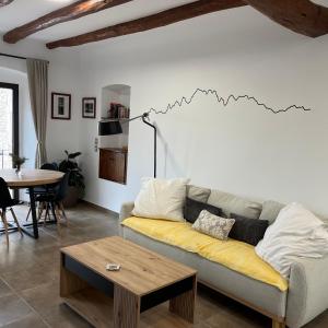 a living room with a couch and a table at La Casa Vella in Navarcles