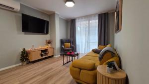 a living room with a couch and a chair at By The Pool Apartments #8 in Velingrad