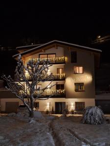 a building with a tree in front of it at night at Piz Buin in Kappl