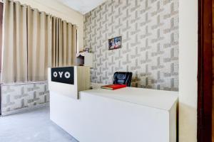 an office with a white desk with a sign on it at Hotel O DREAM INN in Alwar